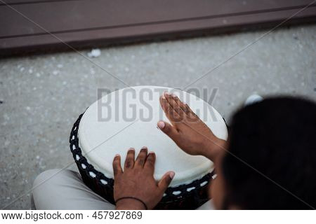 Drumming The Palm Of The Hand On A Flat Plate, Playing The Drum Djembe, Rhythm Banging Hands, A Blac