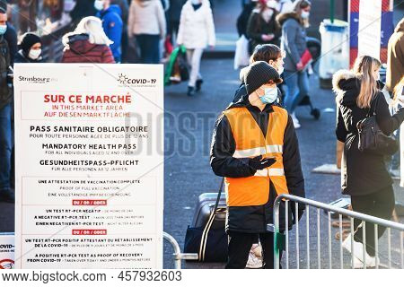 Strasbourg, France - Dec 17, 2021: Surveillange Of Christmas Market - Visitors And Gauard Wearing Re