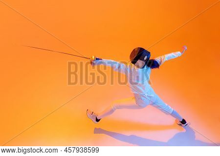 Aerial View Of Professional Fencer In White Fencing Costume And Mask In Action, Motion Isolated On O