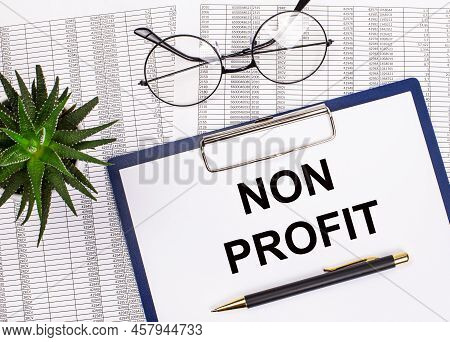 Folded Business Papers, Pen, Glasses, A Flower In A Pot And A Tablet With A Sheet Of Paper With The 