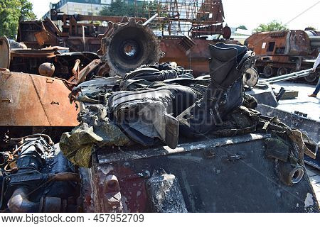 Destroyed Russian Military Equipment With The Remains Of The Military Uniform Of Enemy Soldiers. Exp