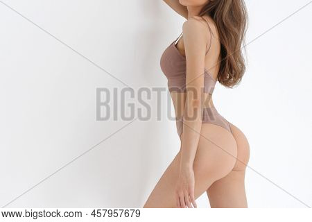 Fitness Model With Beautiful Buttocks Behind View. Legs And Booty Of Young Slim Girl In Sexy Sports 