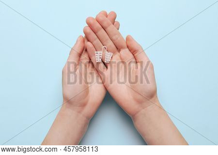 Woman Holding Anti-snoring Device For Nose On Turquoise Background, Top View