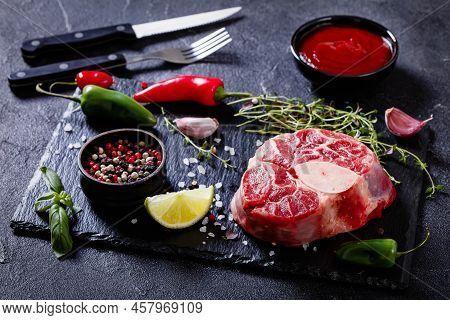 Uncooked Osso Buco, Veal Shank Steak With Marrowbone On Black Stone Board With Peppercorns, Fresh Th