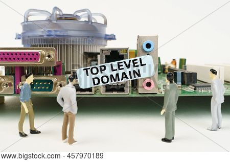 Technology And Computer Concept. Figures Of People Are Standing Near The Motherboard And Looking At 