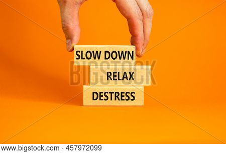 Destress Symbol. Concept Words Slow Down Relax Destress On Wooden Blocks. Beautiful Orange Table Ora