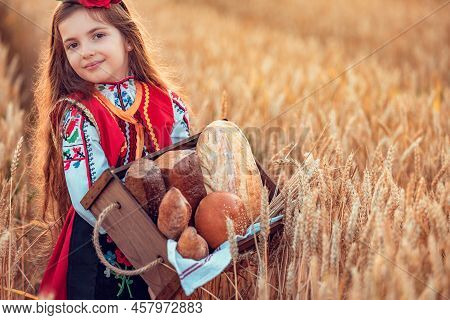 Beautiful Girl Woman In Traditional Bulgarian Folklore Dress Holding Wicker Basket With Homemade Bre