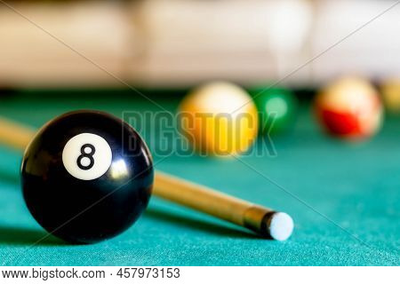 Billiard Eight Ball On Green Tapestry And More Balls In The Backgrownd