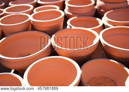 Close-up Of Empty Clay Flower Pots In Greenhouse Or Hothouse. Pots For Planting. Gardening And Lands