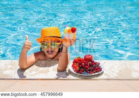 Child Drink Cocktail. Summer Child By The Pool Eating Fruit And Drinking Lemonade Cocktail. Summer K