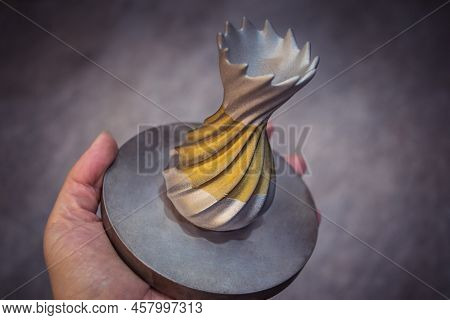 Man Is Holding Object Printed On Metal 3d Printer. Object Printed In Laser Sintering Machine. Modern