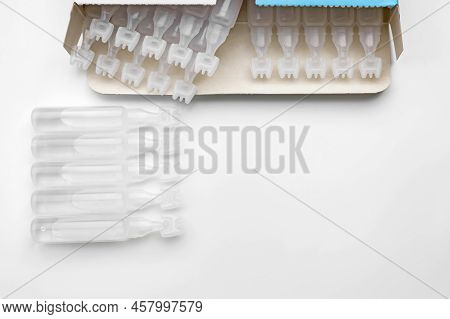 Single Dose Ampoules Of Sterile Isotonic Sea Water Solution On White Background, Top View