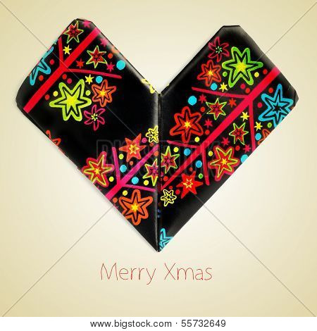 an origami heart and the sentence merry christmas on a beige background with a retro effect