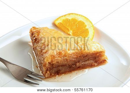 Baklava served with  a slice of orange