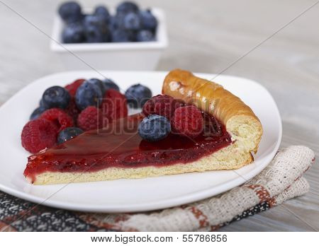 Slice Of Raspberry Pie With Fresh Berries On A Plate