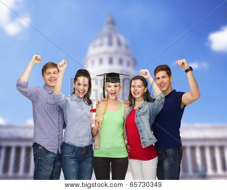 education and people concept - group of standing smiling students with diploma and corner-cap