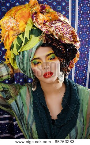 beauty bright woman with creative make up, many shawls on head like cubian woman