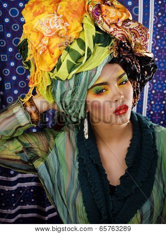 beauty bright woman with creative make up, many shawls on head like cubian woman