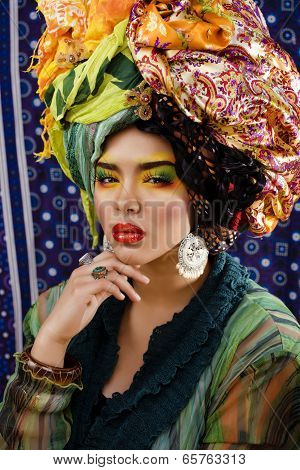 beauty bright woman with creative make up, many shawls on head like cubian woman