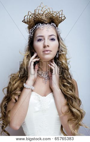 beauty young snow queen in fairy flashes with crown on her head