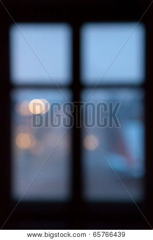 Defocused window frame with city lights behind