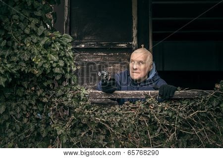 Masked Senior Man Aiming A Gun