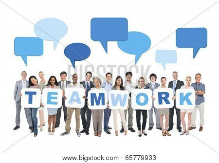 Multi-Ethnic Group Of Business And Casual People Holding Cardboards Forming Teamwork And Empty Speech Bubbles Above.