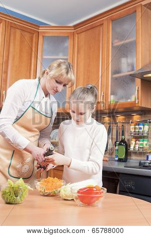 Cute Caucasian Mother and Teenage Daughter Preparing Vegetables