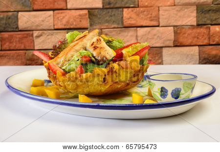 Colombian cuisine. Chicken salad on a platano bowl.