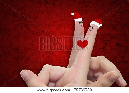 Concept or conceptual old vintage red pattern paper background with man and woman finger in love with Christmas hats and a heart painted, metaphor to family, couple, celebration, holiday, roamnce card
