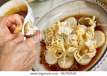 Lontong mie in Indonesian for its famous traditional food, or in English maybe spelled rice cake and noodle in vegetable soup