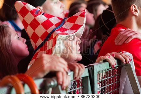ZAGREB, CROATIA - JUNE 12, 2014: Elderly woman wearing hat in Croatian colors at Ban Josip Jelacic square support  national team during the world cup match between Croatia and Brazil.
