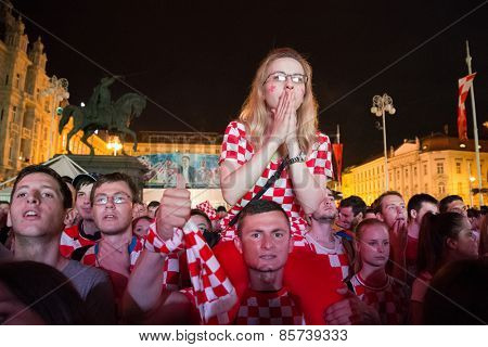 ZAGREB, CROATIA - JUNE 12, 2014: Croatian football fans at Ban Josip Jelacic square support their national team during the world cup match between Croatia and Brazil.