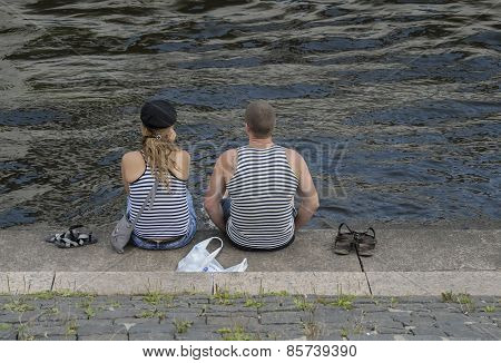 Young married couple are on the river bank