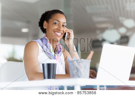 Beautifiul young businesswoman talking over phone