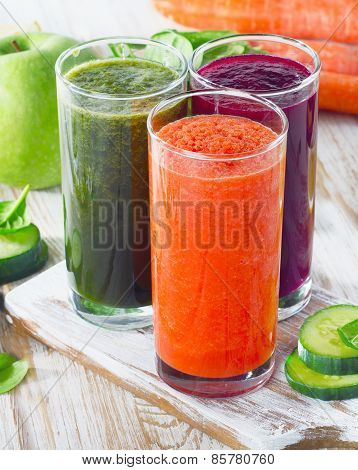 Vegetable Juices On A White Wooden Background
