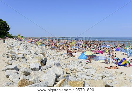 USTKA - JULY 04: Tourists enjoy the sunny weather and relaxing on the Baltic sea beach on 04 July 2015 in Ustka, Poland.