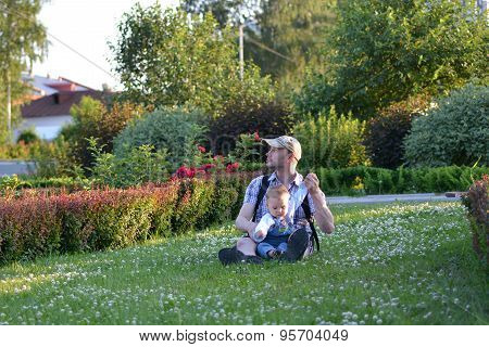 Father and son playing on summer green grass