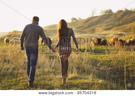 Couple Holding Hand In Hand Romantic Walk On The Autumnal Meadow