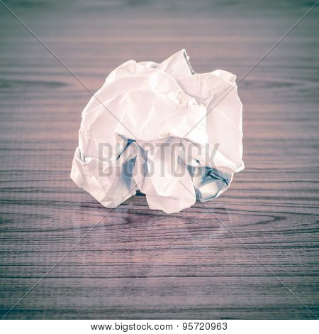 white crumpled paper on wood table background