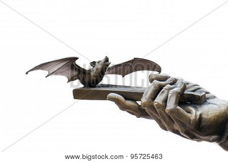 Bat and hand part of brass sculpture isolated on white background