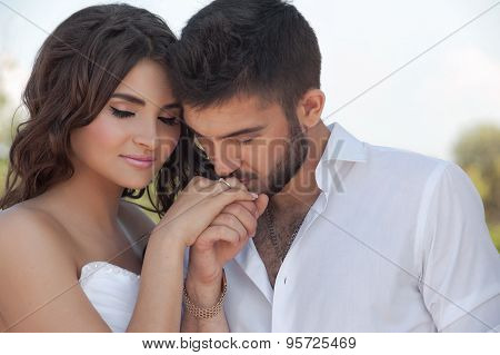 Groom in white shirt kiss bride hand. Very gentle photo.Valentine day