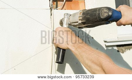 The Process Of Drilling Holes In The White Polyfoam