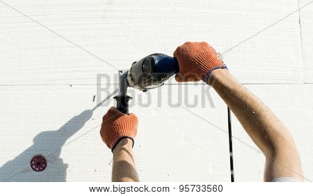 The Process Of Drilling Holes In The White Polyfoam