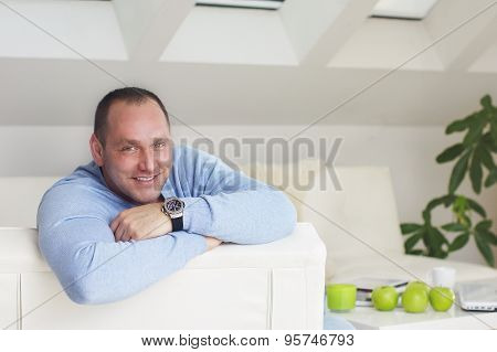 Handsome business man smile into camera in office