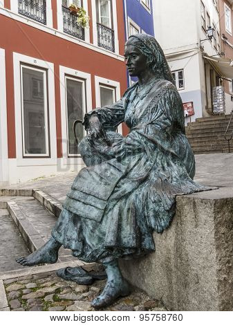 Statue Of Sitting Woman Carrying A Pitcher Of Water