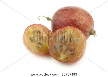 gooseberry and a cut one (Ribes uva-crispa) on a white background