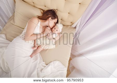 Mother Kisses The Firstborn, Lying On Sofa.