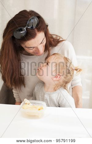 Baby Eating And Looking Mother