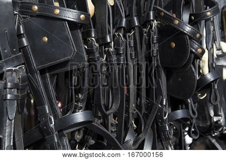 Black colored leather harnesses for riders for sale at farmers market